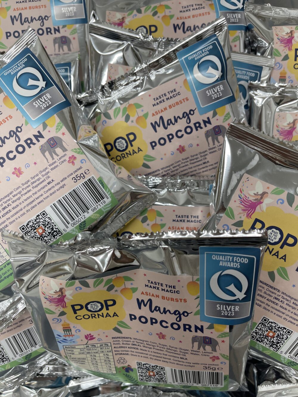 35g bag of award-winning Popcornaa Asian Mango popcorn, featuring a delicious, tropical mango flavor with a unique Asian twist.